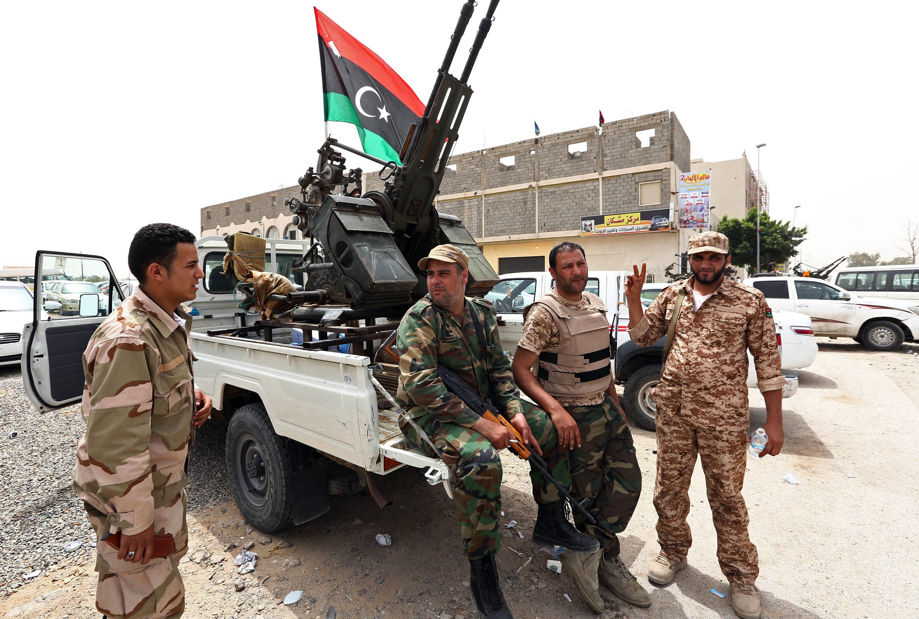 Libyan gunmen surround the Libyan Justice Ministry demanding a ban against those who worked under the former regime of ousted leader Moamer Kadhafi from holding senior positions on April 30, 2013, in the capital Tripoli. Gunmen have said their siege of the ministries would be lifted when their demands are met by a vote in the General National Congress -- Libya's highest political authority -- on a bill calling for the expulsion of former regime employees. AFP PHOTO / MAHMUD TURKIA
