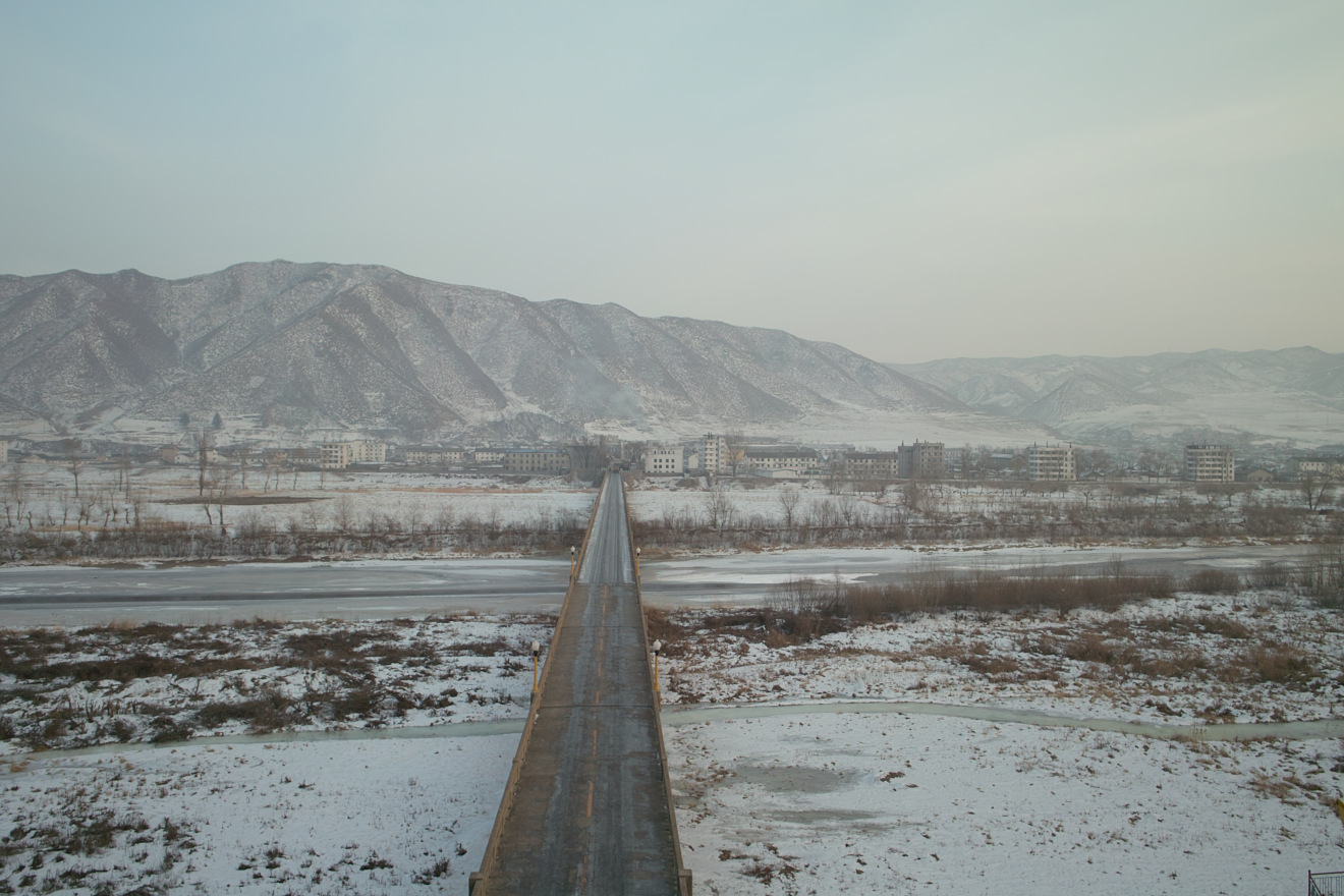 The Tumen River, at the border between North Korea and China, and the bridge which crosses the Tumen River into North Korea. Picture taken from the Chinese side of the Tumen River at Tumen City; the city of Namyang, North Korea is across the river. / China North Korea