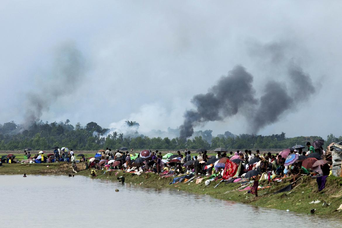 Smoke billows above a burning village in Maungdaw as members of the Rohingya Muslim minority take shelter in a no-man's land between Bangladesh and Myanmar in Ukhia on September 4.