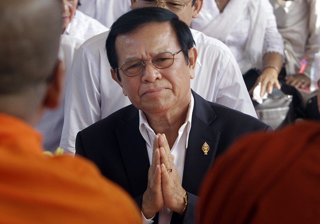In this Thursday, March 30, 2017, file photo, opposition leader of the Cambodia National Rescue Party Kem Sokha prays during a Buddhist ceremony to mark the 20th anniversary of the attack on anti-government protesters in 1997, in Phnom Penh, Cambodia. Police have arrested the Kem in a surprise raid on his home early Sunday, Sept. 3, 2017. The government issued a statement accusing Kem Sokha of treason, saying he conspired with foreign powers against Cambodia.