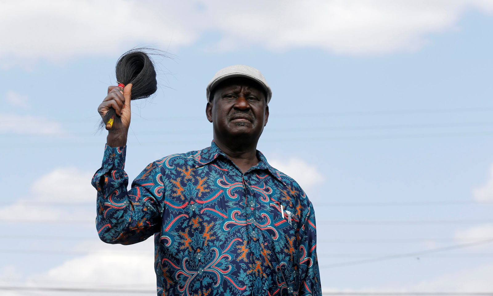Opposition leader Raila Odinga greets supporters as he arrives to address a rally in Kibera slum, Nairobi