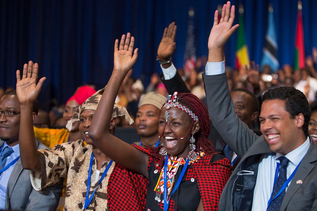 People taking part in the Young African Leaders Initiative town hall raise their hands as President Barack Obama delivers remarks a the summit in Washington, D.C., July 28, 2014.