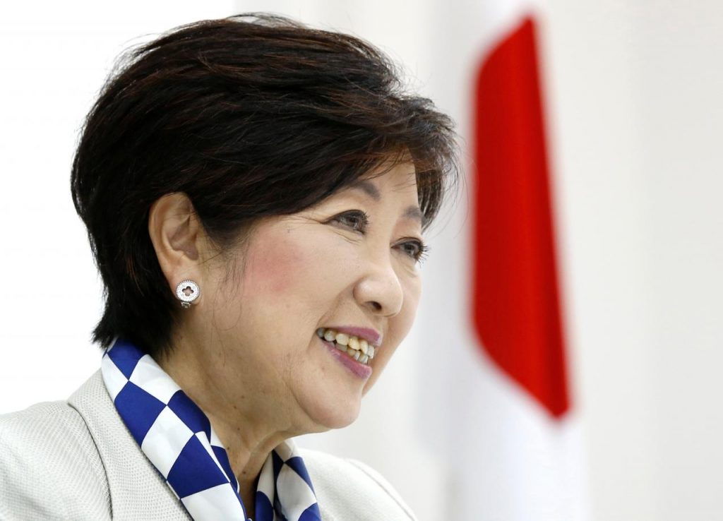 Tokyo Governor Yuriko Koike, head of Japan's Party of Hope, smiles next to a Japanese national flag during an interview with Reuters in Tokyo, Japan October 6, 2017.