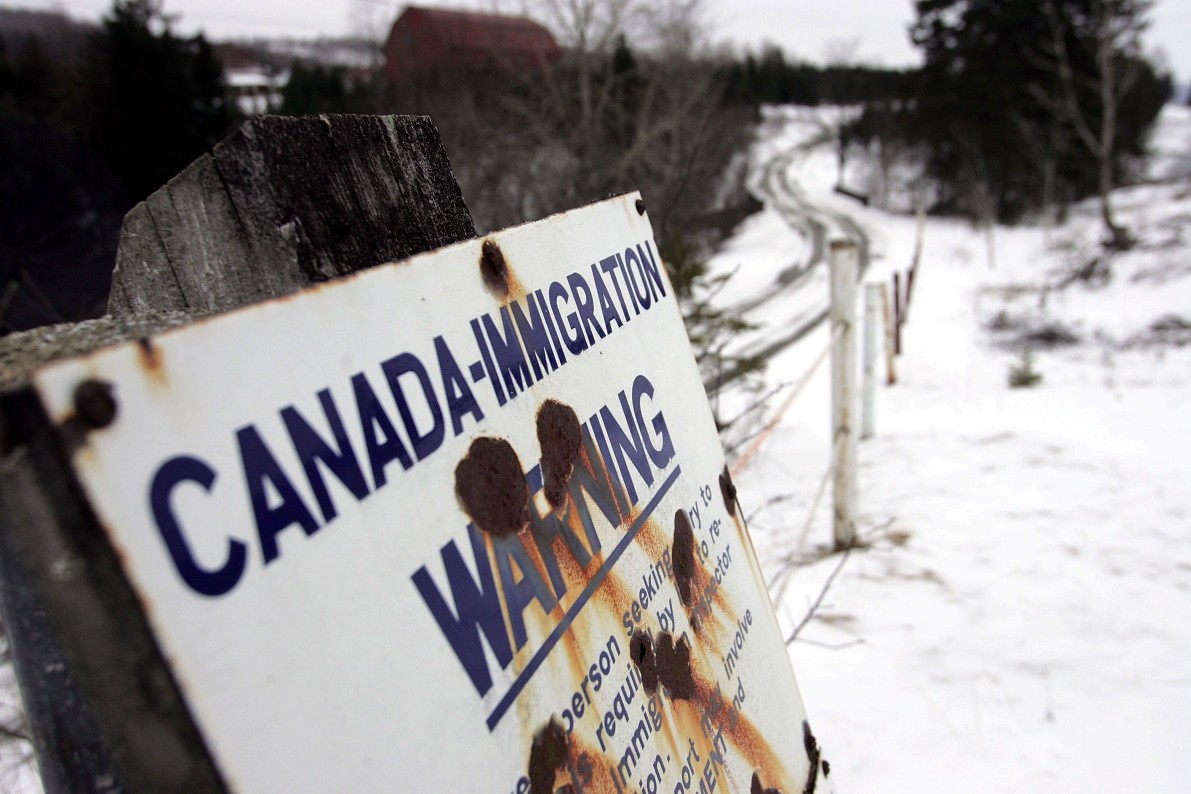 A sign sign marks the border between Canada and the U.S. March 22, 2006 near Beecher Falls, Vermont. As American politicians continue to debate immigration reform Border Patrol agents work the northern border to prevent asylum seekers entering.