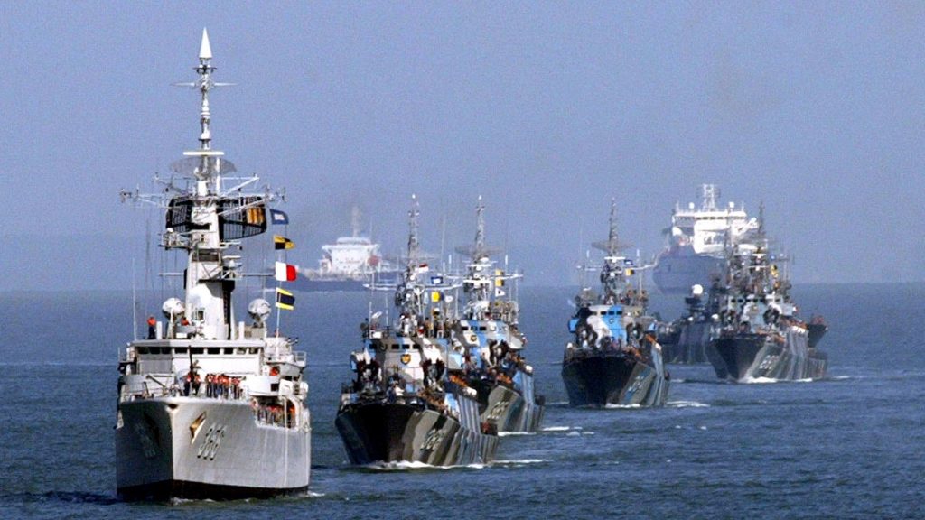 Naval ships from Indonesia, Singapore and Malaysia sail during a ceremony to launch a trilateral coordinated patrol between the three countries in the Strait of Malacca on July 20, 2004.