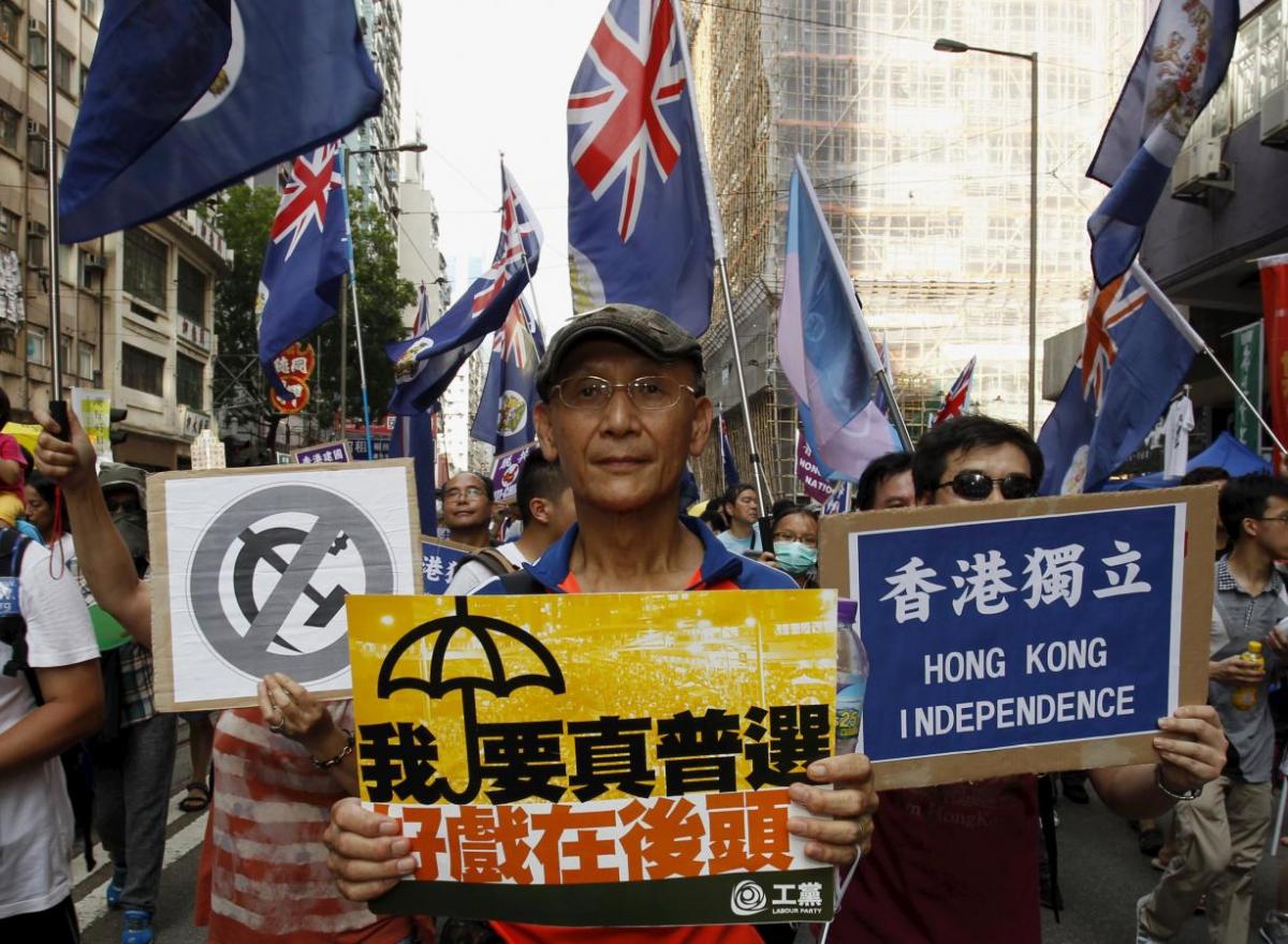 A protester carries a placard which reads “I need real universal suffrage” during a demonstration in Hong Kong
