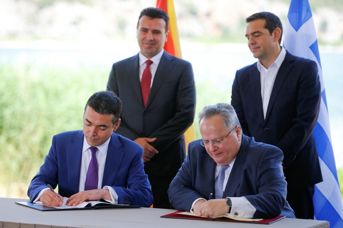 Greek Foreign Minister Kotzias and his Macedonian counterpart Dimitrov sign an accord to settle a long dispute over the former Yugoslav republic’s name in the village of Psarades