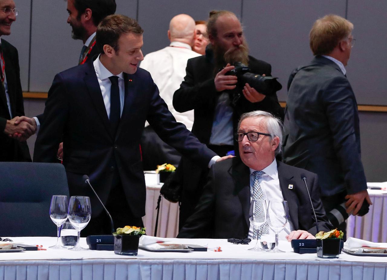 French President Emmanuel Macron talks with European Commission President Jean-Claude Juncker during a European Union leaders informal summit in Brussels