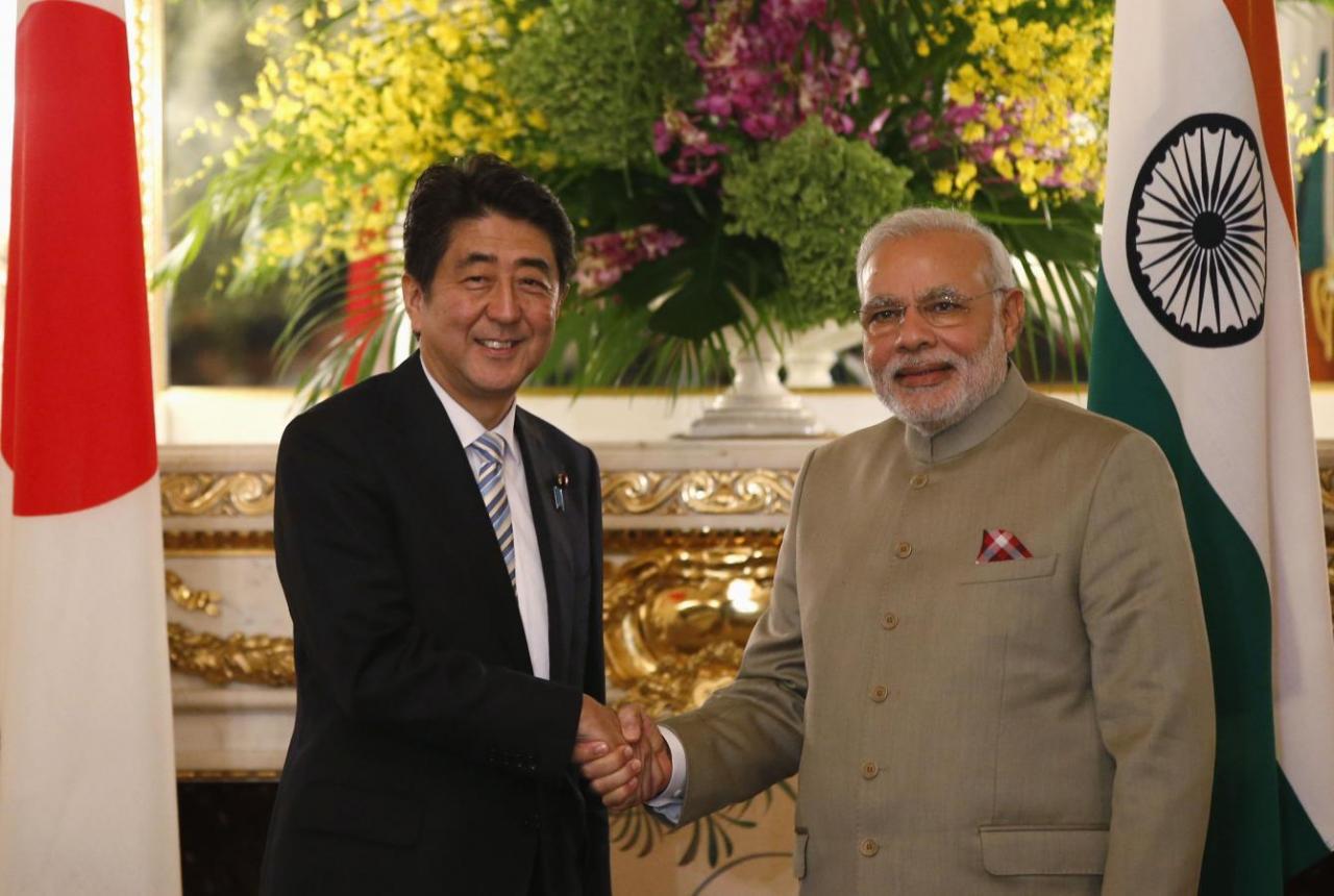 India’s PM Modi and Japan’s PM Abe shake hands before their talks at the state guest house in Tokyo