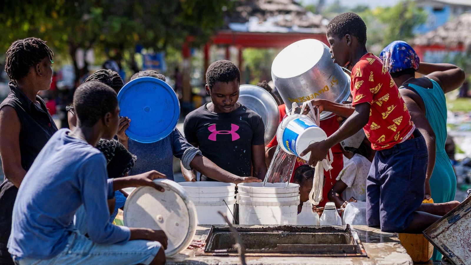 Citizens in Haiti getting water out of a well due to the ongoing cholera epidemic
