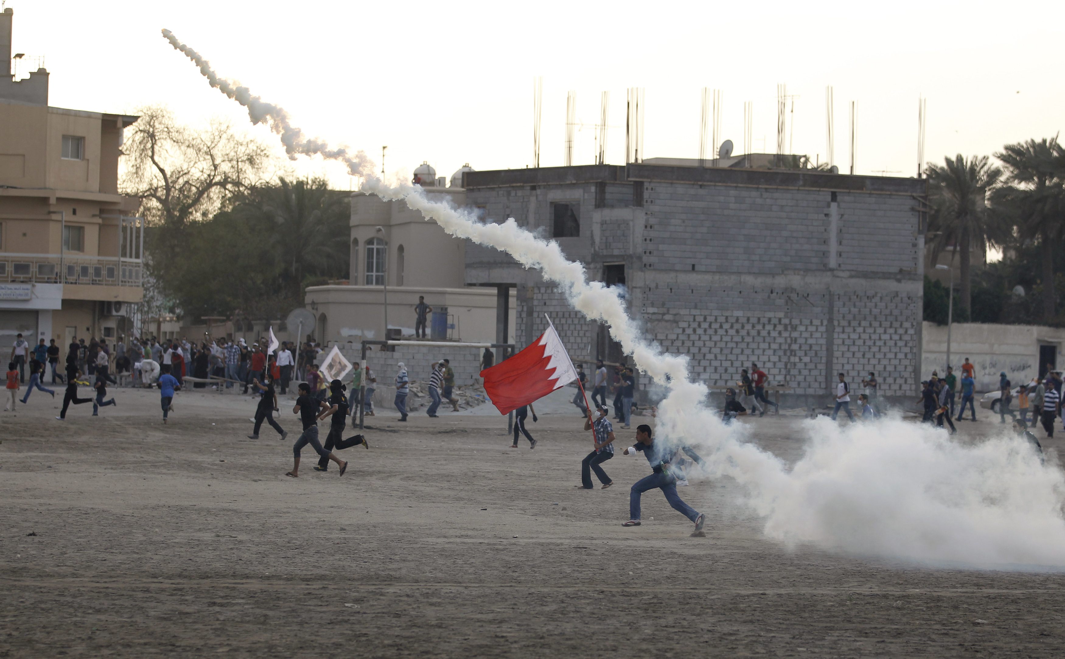 Anti-government protesters run towards riot police during clashes after a march held in support of human rights activist Abdulhadi al-Khawaja, in the village of Sanabis, west of Manama April 6, 2012. Al-Khawaja, a jailed Bahraini activist who has been on hunger strike for 58 days was moved to a hospital and fed intravenously on Friday after his health deteriorated sharply, his lawyer said. REUTERS/Hamad I Mohammed (BAHRAIN - Tags: CIVIL UNREST POLITICS)