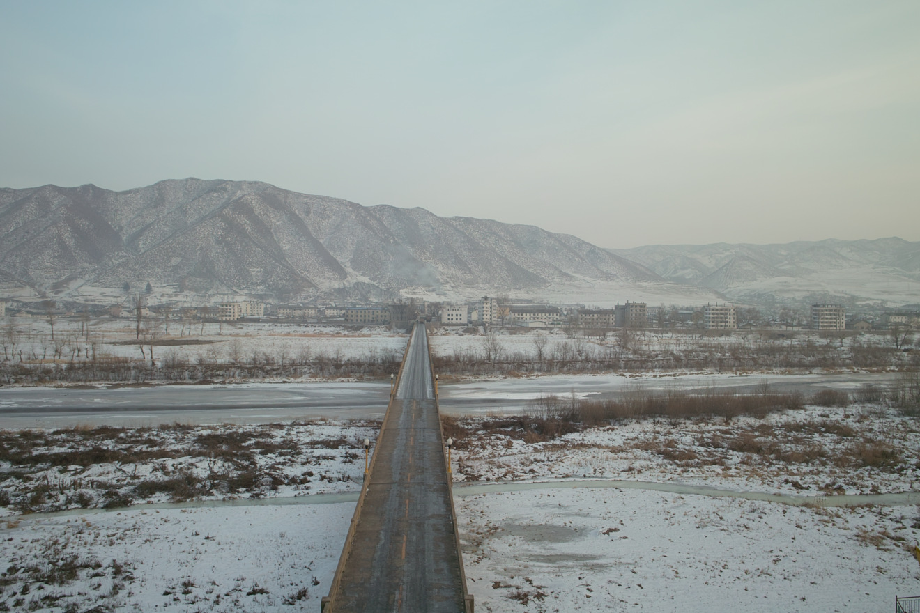 The Tumen River, at the border between North Korea and China, and the bridge which crosses the Tumen River into North Korea. Picture taken from the Chinese side of the Tumen River at Tumen City; the city of Namyang, North Korea is across the river. / China North Korea