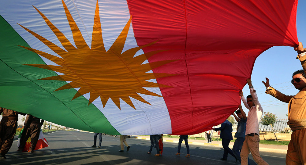 Supporters carry the Iraqi Kurdish flag