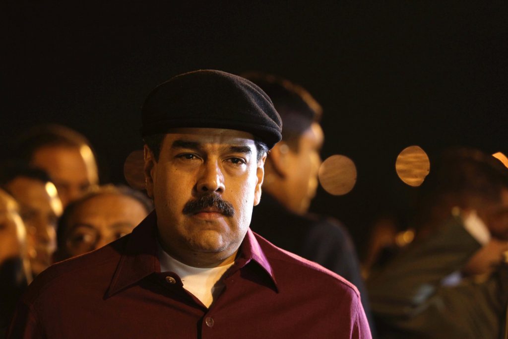 Venezuela's President Nicolas Maduro stands at attention during a welcoming ceremony upon his arrival at Houari-Boumediene airport near the Algerian capital, Algiers