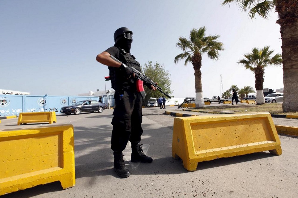 A-member-of-Libyas-security-forces-stands-guard-by-the-government-offices-in-Tripoli.-Reuters.jpg