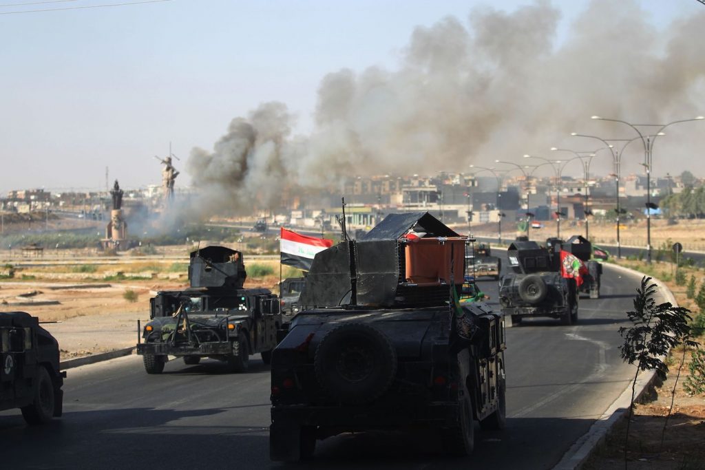 Smoke billows as Iraqi forces advance towards the centre of Kirkuk during an operation against Kurdish fighters on October 16, 2017. Iraqi forces seized the Kirkuk governor's office, key military sites and an oil field as they swept across the disputed province following soaring tensions over an independence referendum.