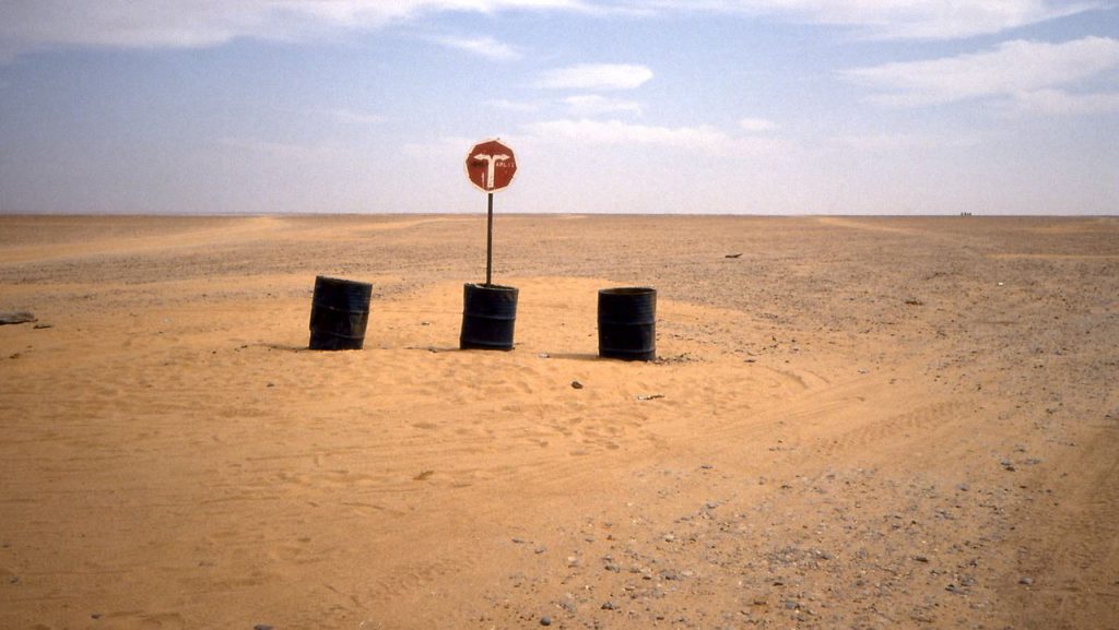 Road sign of the Trans Sahara Highway (Hoggar desert track) in Niger. / ISIS returnees