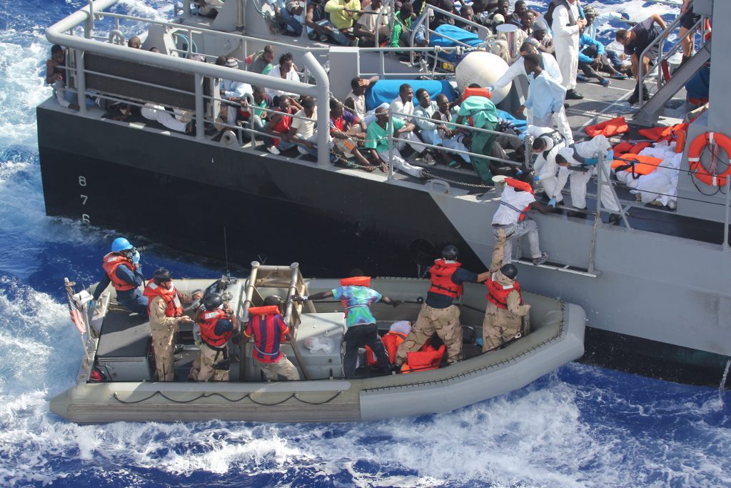 Distressed persons are transferred from the amphibious transport dock ship USS San Antonio (LPD 17) to Armed Forces of Malta offshore patrol vessel P52. San Antonio provided food, water, medical attention, and temporary shelter to the rescued. / Libya deal