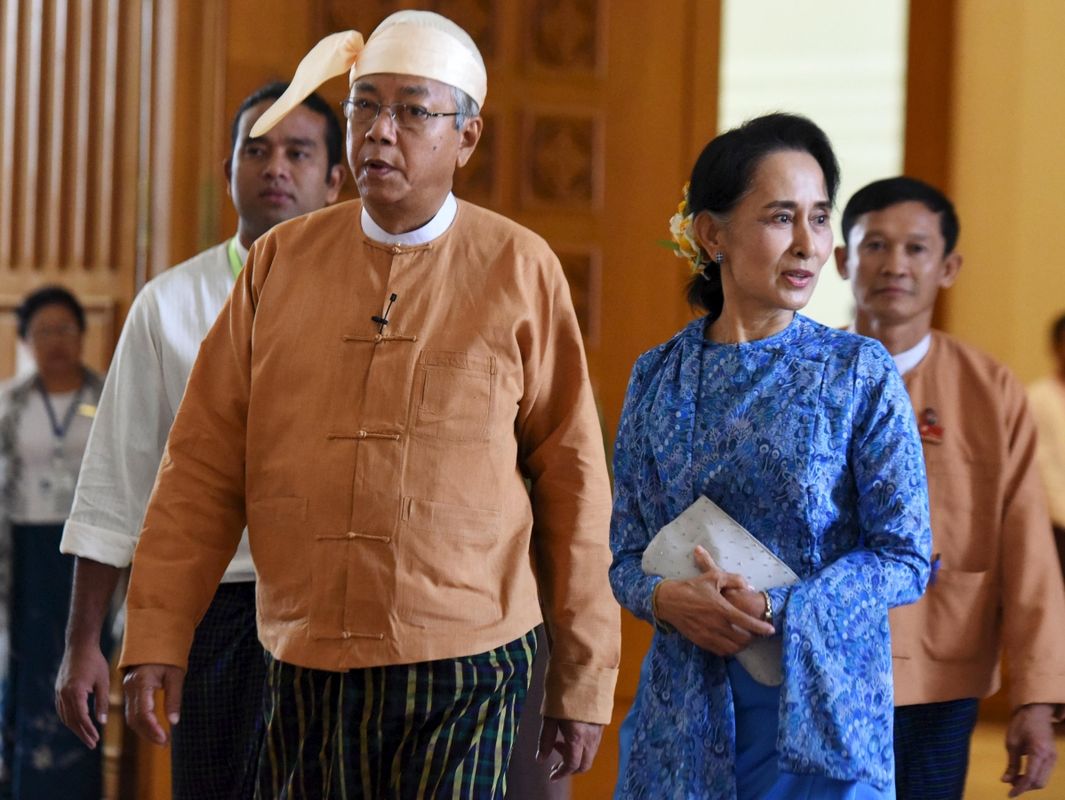 Myanmar’s new president Htin Kyaw (L) and National League for Democracy party leader Aung San Suu Kyi arrives to parliament in Naypyitaw