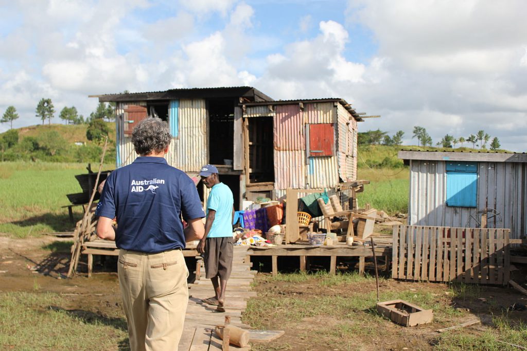 AusAID Minister Counsellor in Fiji, John Davidson, talks with locals about flood damage following Cyclone Evan, 2012. / AusAID
