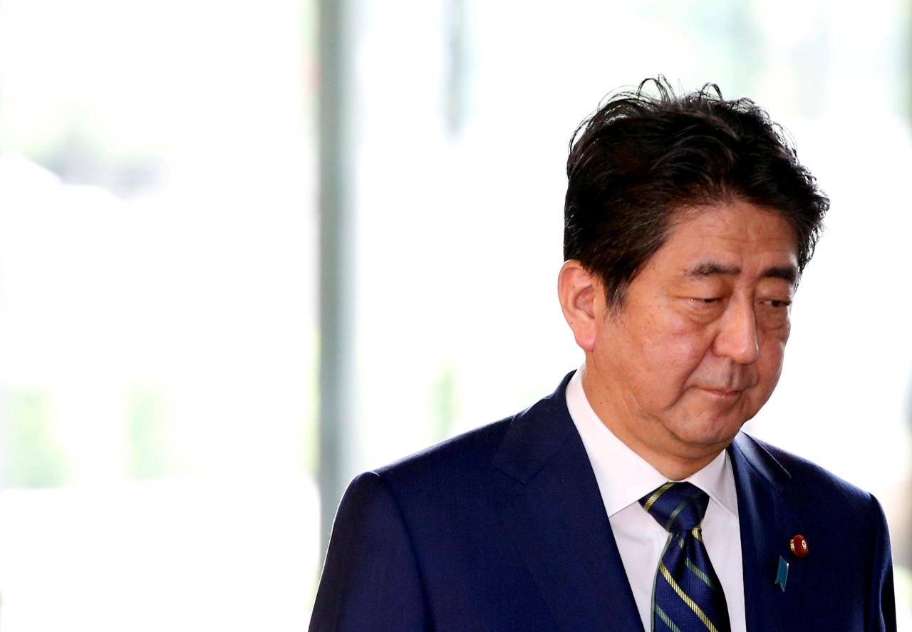 FILE PHOTO: Japan’s Prime Minister Shinzo Abe arrives at his office in Tokyo