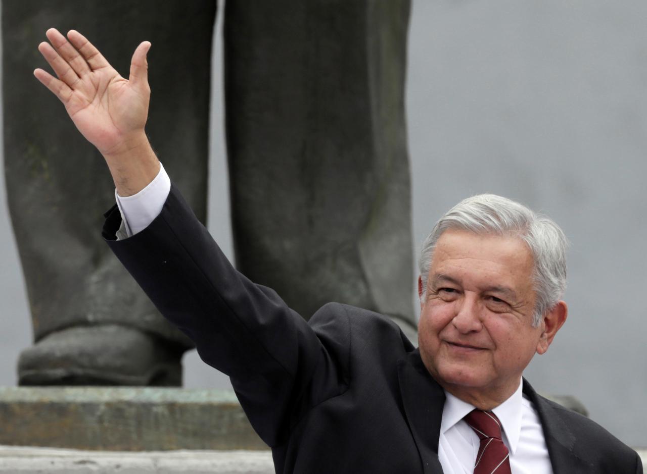 Leftist front-runner Andres Manuel Lopez Obrador greets his supporters after being registered as a presidential candidate of MORENA in Mexico City