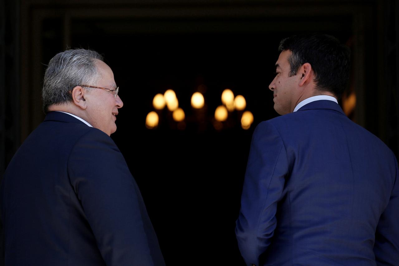 FILE PHOTO: Greek Foreign Minister Nikos Kotzias welcomes his Macedonian counterpart Nikola Dimitrov at the Foreign ministry in Athens