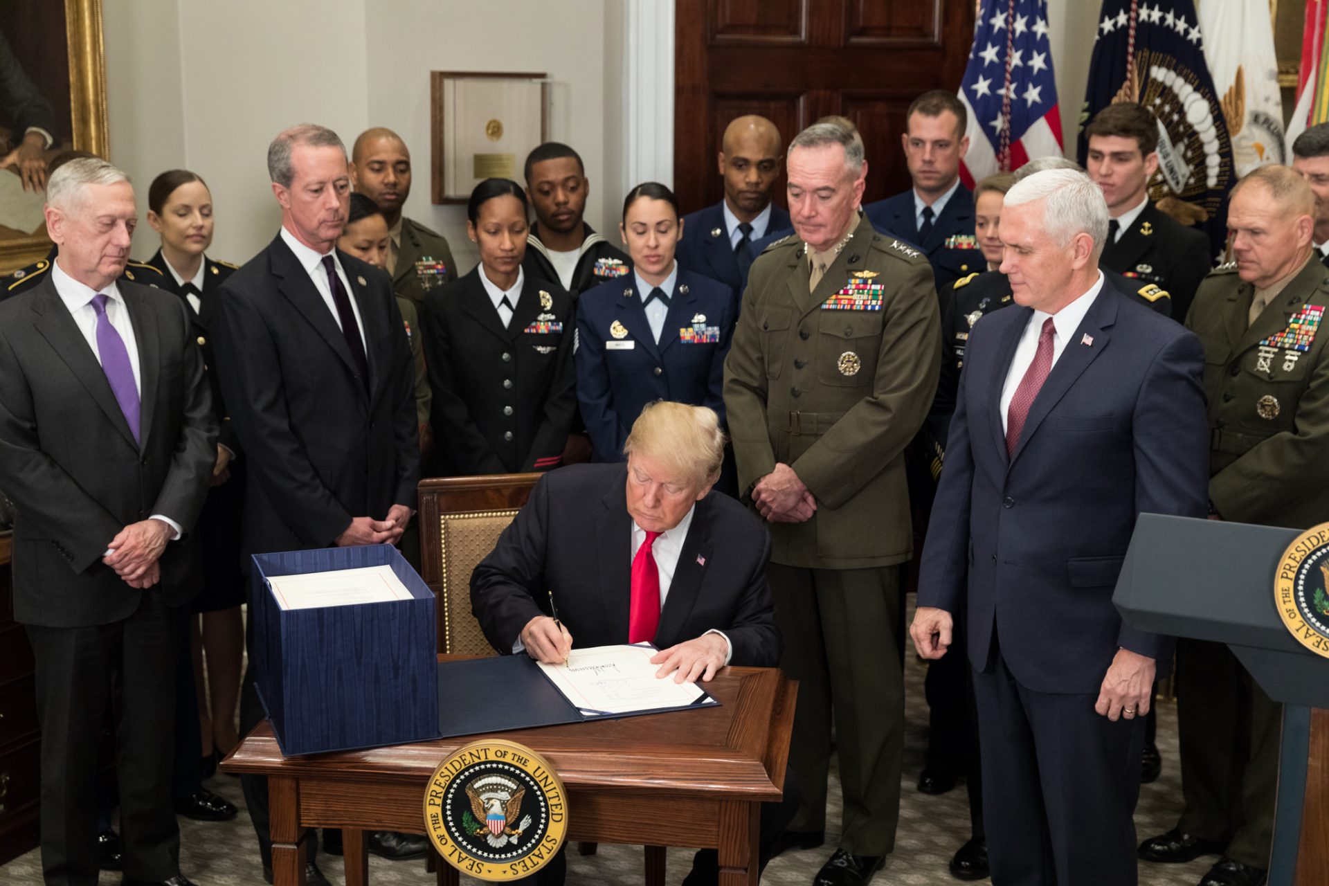 President Donald J. Trump, joined by Vice President Mike Pence and senior military leaders, signs H.R. 2810, the National Defense Authorization Act (NDAA) for fiscal year 2018, in the Roosevelt Room at the White House, Dec. 12, 2017.