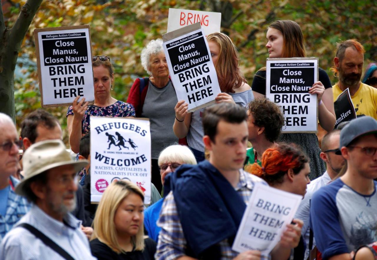 Protesters from the Refugee Action Coalition hold placards during a demonstration outside the offices of the Australian Government Department of Immigration and Border Protection in Sydney, Australia