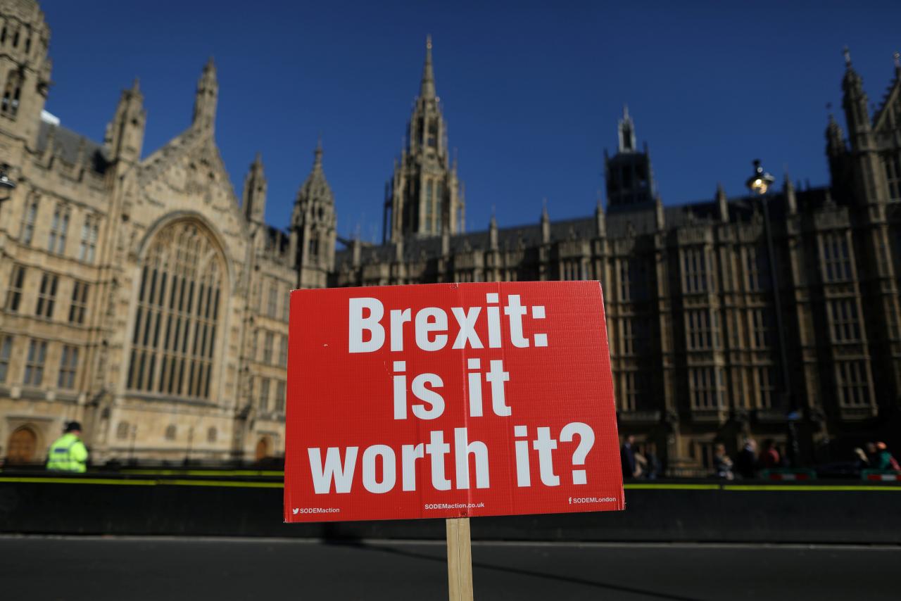 An anti-Brexit placard is fixed to traffic barriers opposite the Houses of Parliament in London