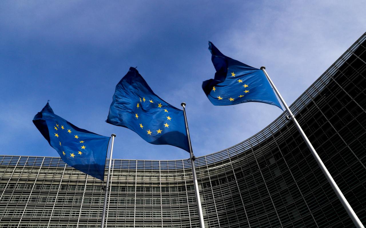 FILE PHOTO: European Union flags flutter outside the EU Commission headquarters in Brussels