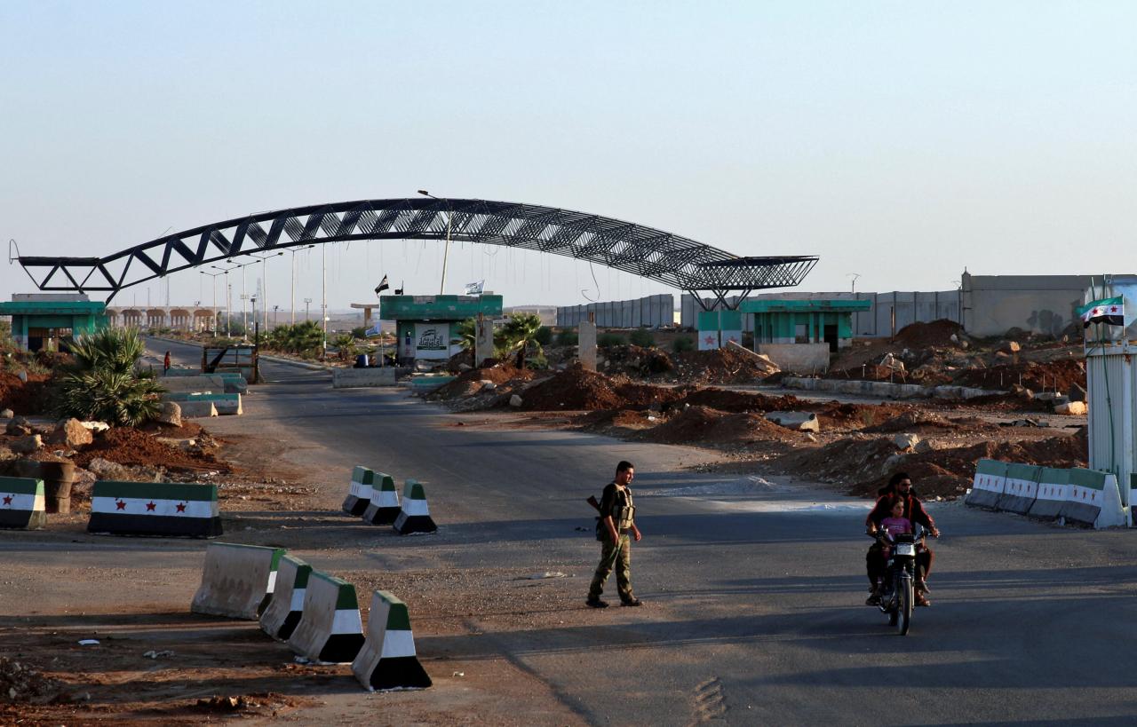 FILE PHOTO:A man rides on a motorbike at the Syrian-Jordanian border at the Nasib crossing in Deraa province