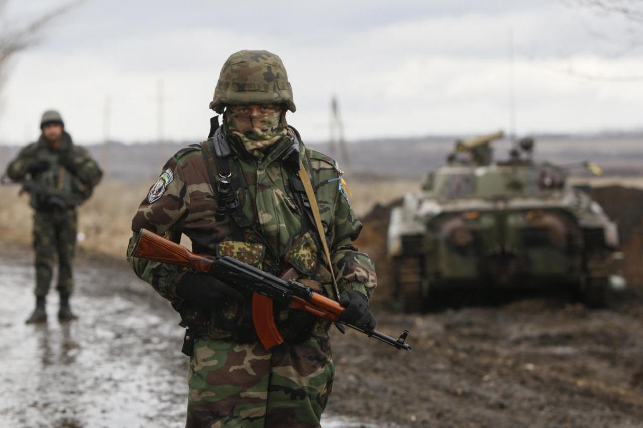 Ukrainian serviceman guards at a checkpoint near the eastern Ukrainian town of Debaltseve in Donetsk region