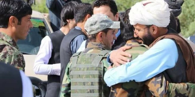 Taliban fighters embrace Afghan army soldiers and officers during the Eid ceasefire in the outskirts of Kabul.