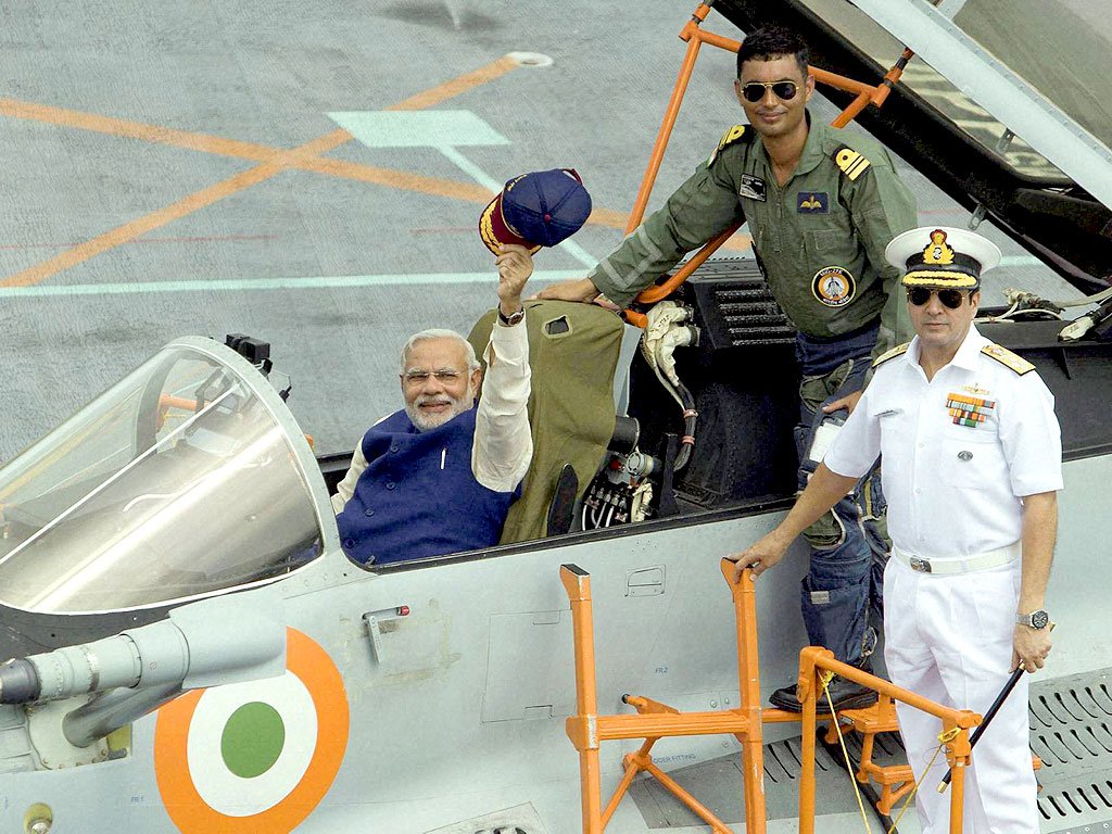 Indian Prime Minister Narendra Modi sitting in a fighter pilot sea